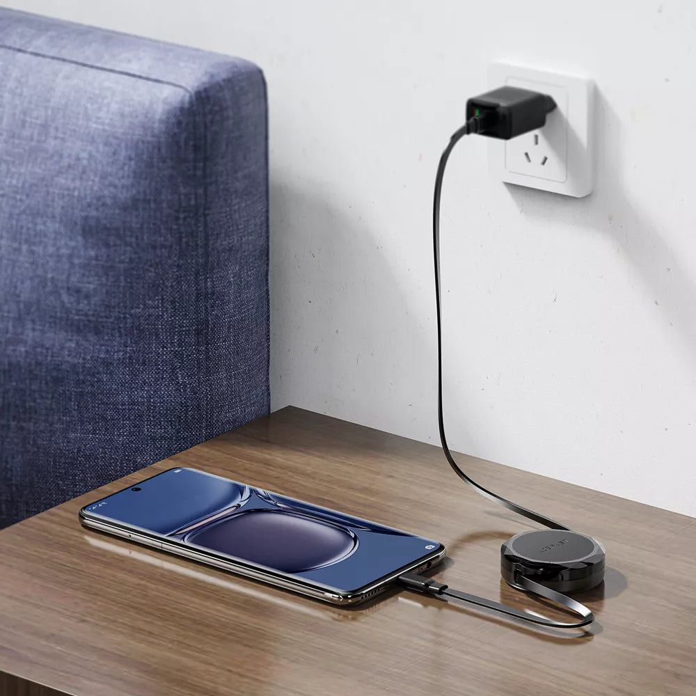 Black Acefast retractable USB-C to USB-C cable partly wound into its housing.